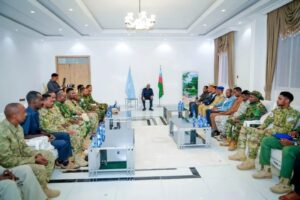 Aden Madobe seated before South West State military commanders at a security meeting in Baidoa