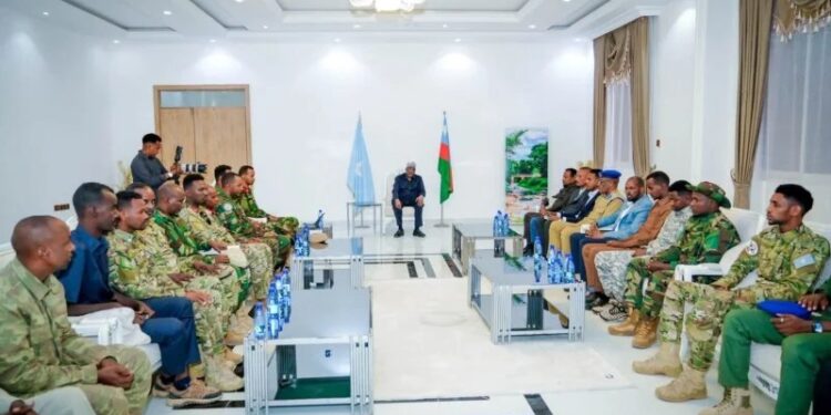Aden Madobe seated before South West State military commanders at a security meeting in Baidoa