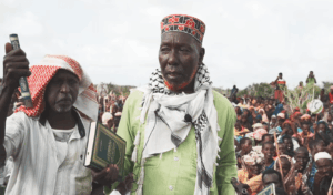 Biyomaal elders hold copies of the Quran before a crowd at KM50 in Lower Shabelle during the land dispute