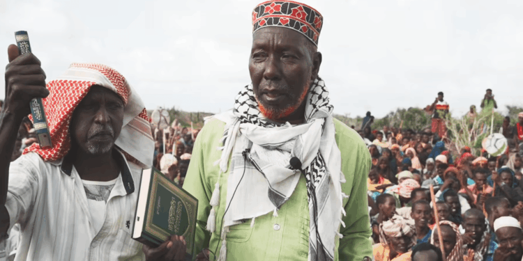Biyomaal elders hold copies of the Quran before a crowd at KM50 in Lower Shabelle during the land dispute