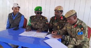 Ethiopian and Somali officers sign the transfer documents at the Buurhakaba base handover in Bay region