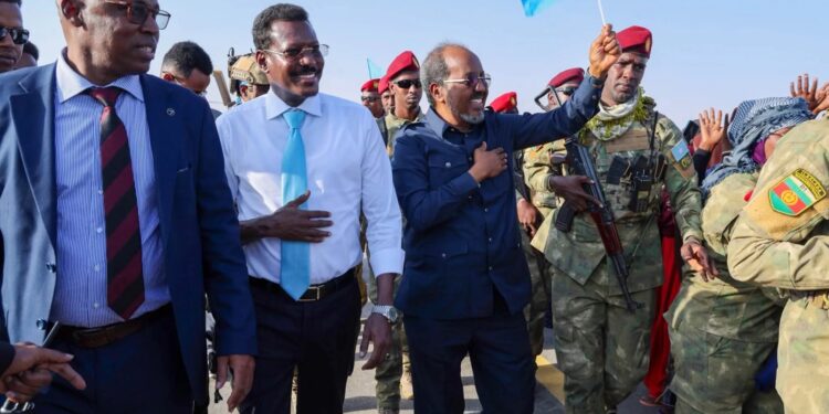 President Hassan Sheikh Mohamud walking on the tarmac in Dhusamareb with Galmudug officials and troops on his arrival
