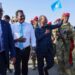 President Hassan Sheikh Mohamud walking on the tarmac in Dhusamareb with Galmudug officials and troops on his arrival