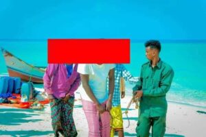 Puntland forces escort detained pirate suspects along the shore as piracy returns to the Nugaal coast
