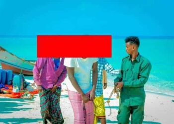 Puntland forces escort detained pirate suspects along the shore as piracy returns to the Nugaal coast