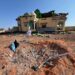 The crater and the wrecked house at Doolow that Fahad Yasin says Speaker Abdulkadir Mohamed Nur ordered struck, still unexamined by any published inquiry