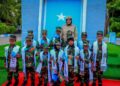 Children of fallen Somali National Army soldiers in uniform and Agoonta Ciidanka sashes with an army officer, the families the Orphans Care Agency was founded to support