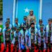 Children of fallen Somali National Army soldiers in uniform and Agoonta Ciidanka sashes with an army officer, the families the Orphans Care Agency was founded to support
