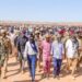 President Said Abdullahi Deni walking with residents and escorts at Gunbax in Raas Caseyr during his tour of Puntland far eastern districts