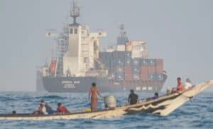 A skiff alongside a cargo ship in the Gulf of Aden, the crossing used to move weapons from the Houthis to al-Shabaab