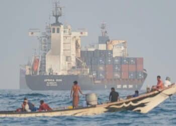 A skiff alongside a cargo ship in the Gulf of Aden, the crossing used to move weapons from the Houthis to al-Shabaab