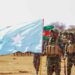 Newly graduated Somali National Army soldiers carry the Somali flag on the parade ground at Xananbuure in Galgadud, the class from which hundreds later crossed into Ethiopia's Somali Region