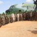 ENDF soldiers serving with AUSSOM in Somalia beside an Ethiopian Air Force transport aircraft during a troop rotation