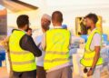 Electoral Commission staff in marked vests with polling materials beside an aircraft, the body that has set Somalia's federal vote for 15 May 2027