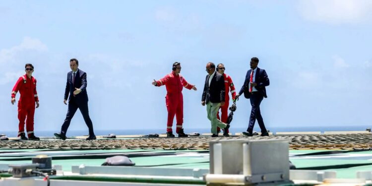 President Hassan Sheikh Mohamud crosses the helideck of the Turkish drillship Cagri Bey at the CURAD-1 well off Mogadishu, October 2026