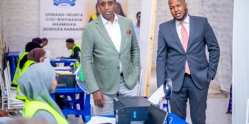 Officials visit a Banadir voter registration centre in Mogadishu run by Abdikarim Ahmed Hassan's electoral commission, with staff in high-visibility vests at the desks