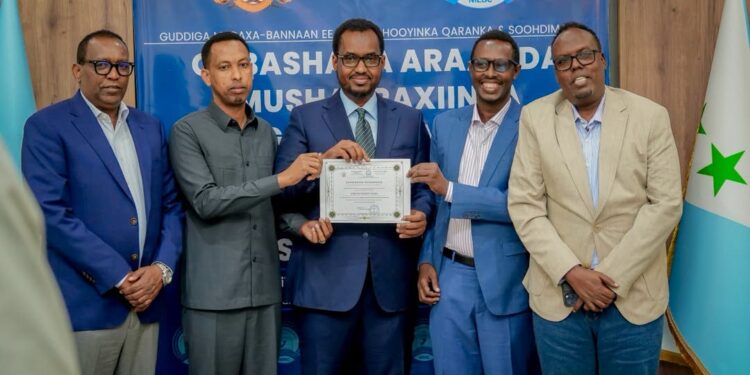 Liibaan Ahmed Hassan's candidacy certificate is presented at an electoral commission ceremony ahead of the Galmudug presidential vote