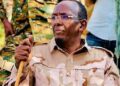Abdullahi Sanbalolshe, the former NISA director, in desert fatigues with a walking stick among soldiers
