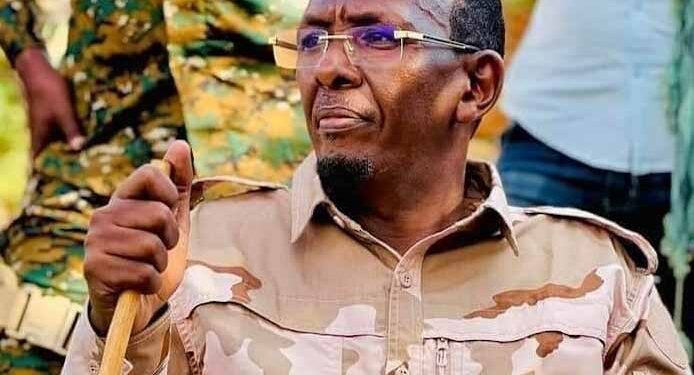 Abdullahi Sanbalolshe, the former NISA director, in desert fatigues with a walking stick among soldiers